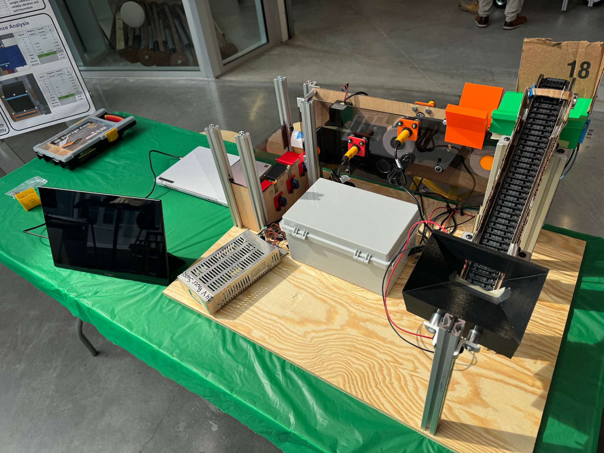 Built system on the bench , conveyor, electronics enclosure, and sorter hardware.